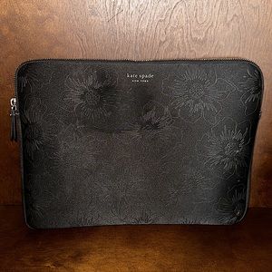 Kate Spade laptop tote with golden slatted zipper with tassel.